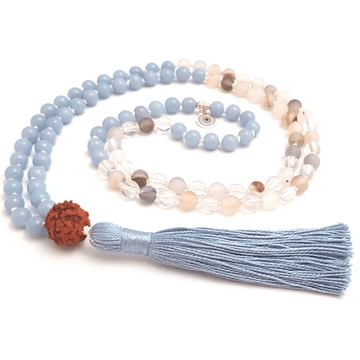 Handmade Throat Chakra Mala – Angelite, Quartz, Agate & Rudraksha necklace curled on table